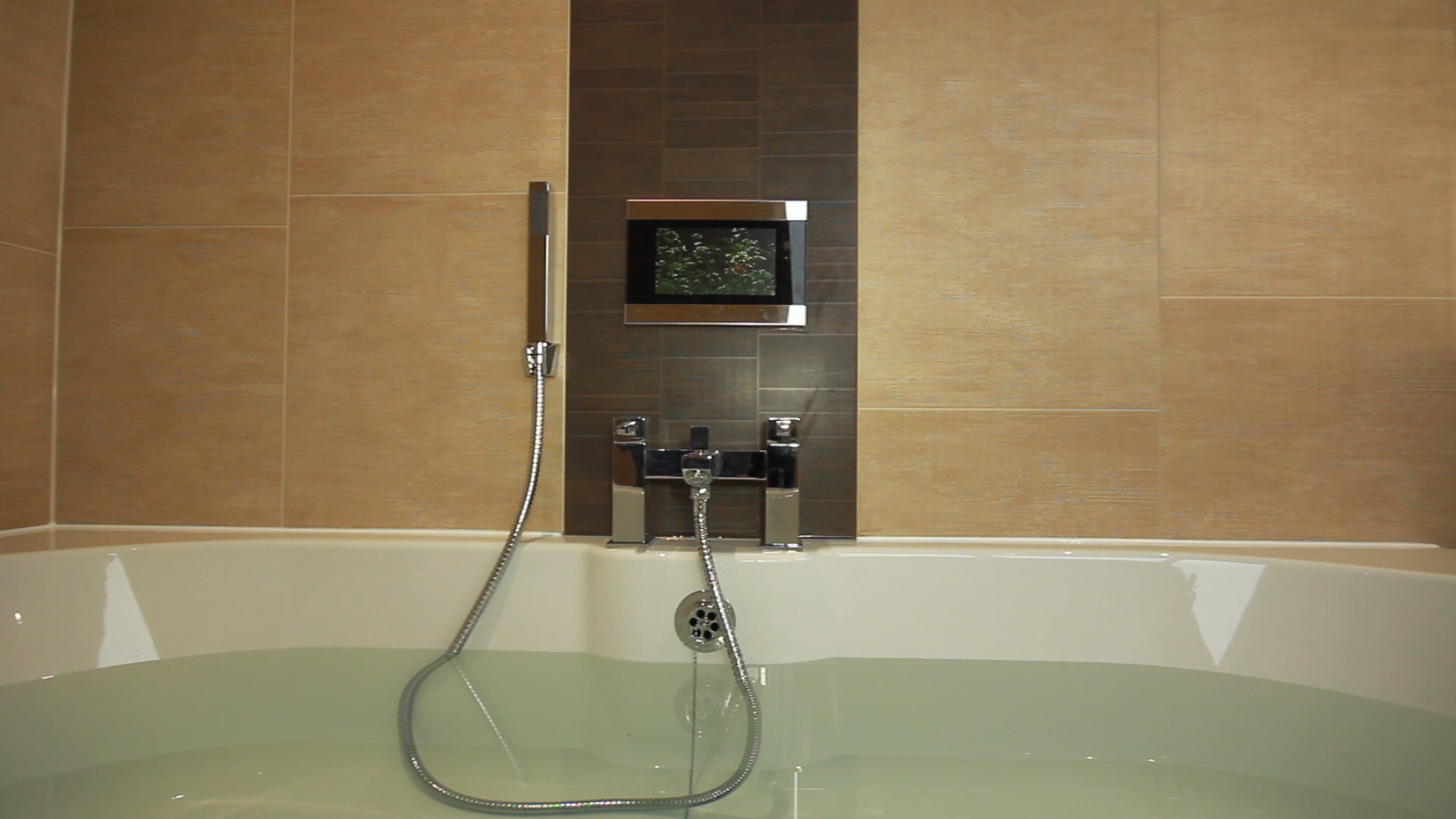Photo of Audio Visual Bathroom Solution in situ showing a TV Screen fitted over the bath